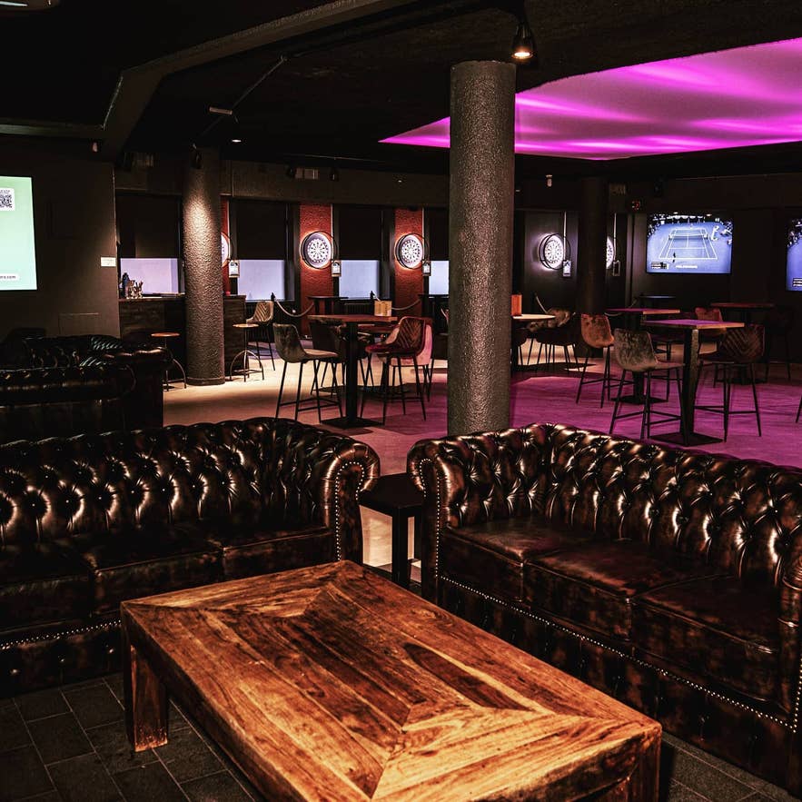 Comfortable seating and dart setups at Bullseye, a casual entertainment spot in Reykjavik.