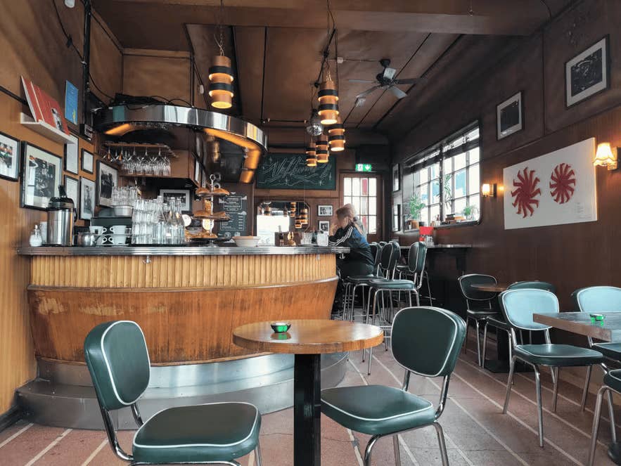 Cozy, retro-themed bar interior at Prikid with classic wooden furnishings.