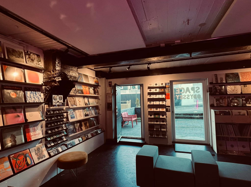Interior of Space Odyssey record store with vinyls, tapes, and zines on display.