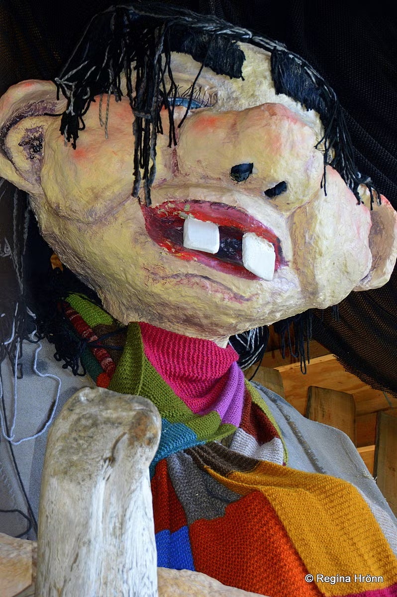 Giantess in the Mountain statue with colorful clothes and exaggerated teeth near Duus Museum in Keflavik, Iceland.