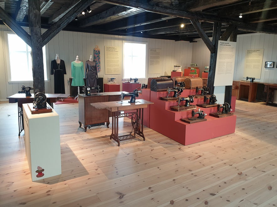Cozy attic gallery space at Duus Museum showcasing Icelandic art and wooden beams.