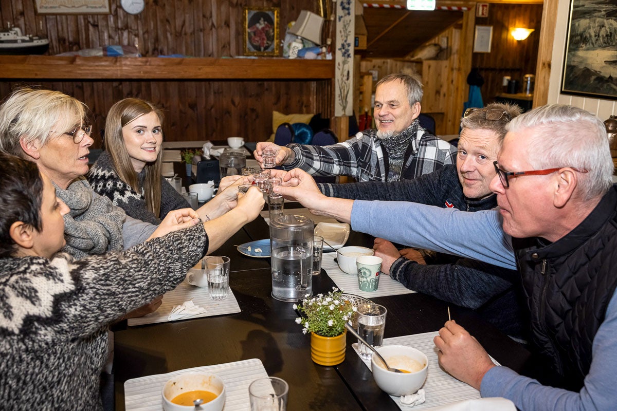 A group of Reykjavik travelers toasts with a drink on this Christmas food tour.
