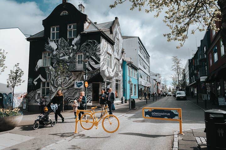 A house adorned with black and white graffiti stands out in the vibrant streets of Reykjavik.