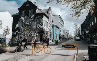 A house adorned with black and white graffiti stands out in the vibrant streets of Reykjavik.