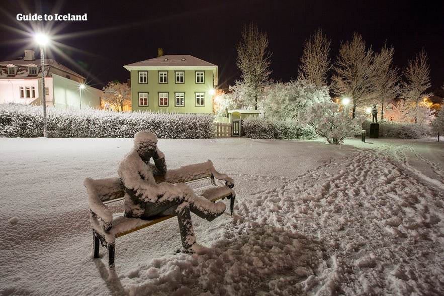 Statue of Tomas Gudmundsson covered in snow in Hljomskalagardur Park, Reykjavik.