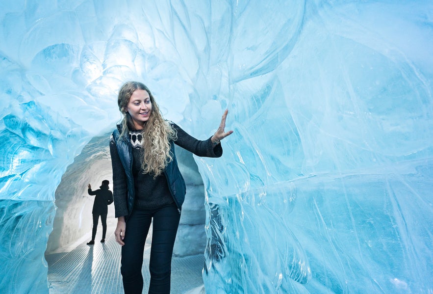 Visitor walking through the ice tunnel exhibit at Perlan Museum in Reykjavik.