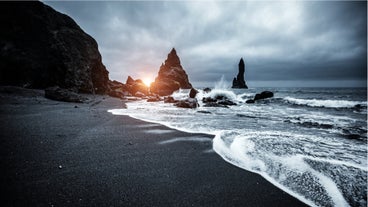 Reynisfjara beach on the South Coast of Iceland has black volcanic sands and mighty waves of the North Atlantic Ocean.