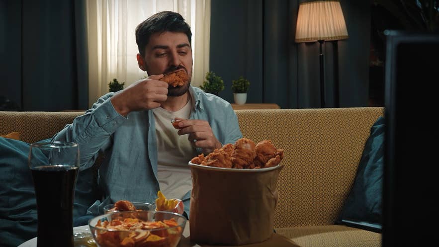 Man spending time at home with fast food delivery