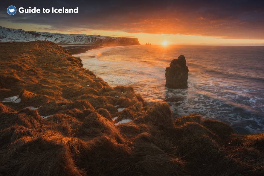 Sunset over Dyrhólaey and Reynisdrangar sea stacks on Iceland's south coast in winter