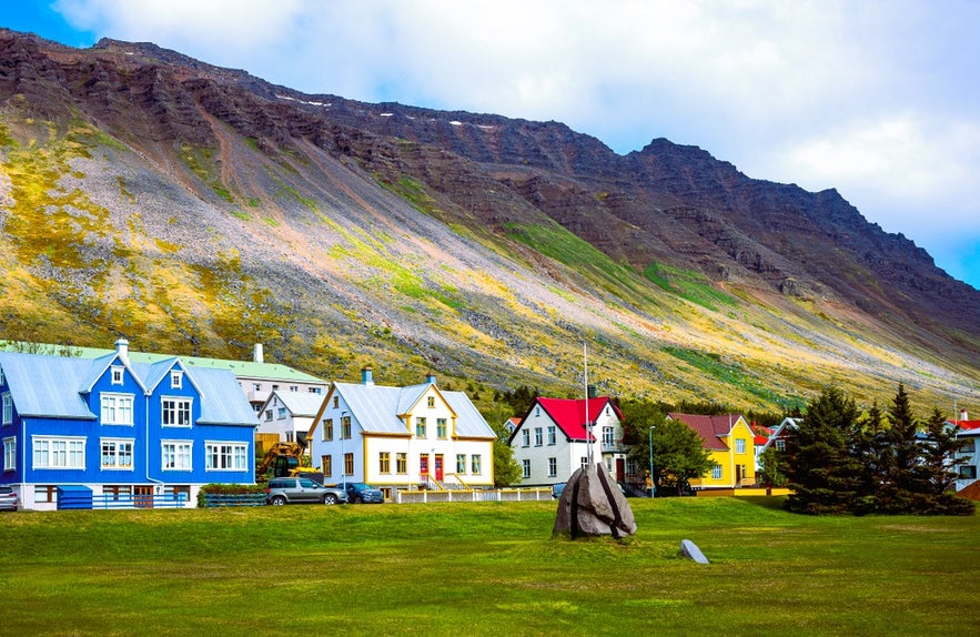 Colorful houses in Isafjordur Iceland with mountain backdrop, a charming sight among the best things to do in Isafjordur.
