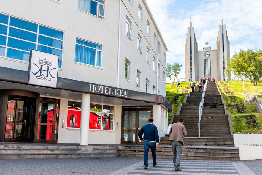 Hotel Kea in Akureyri, Iceland with people walking toward the iconic Akureyrarkirkja church stairs.