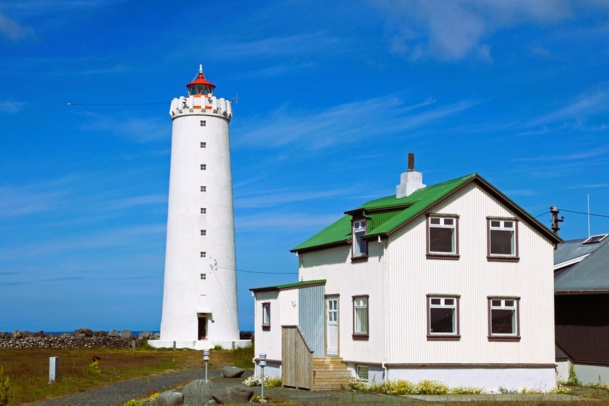 Grotta Lighthouse is one of the secret spots and hidden gems in Reykjavik, with a white tower and green-roofed house.