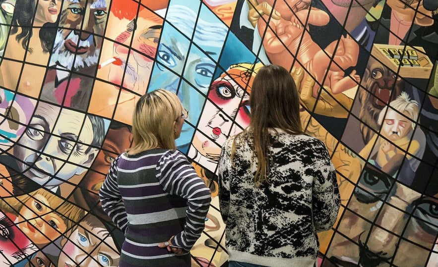 Museum guists viewing a work by Erro at the Reykjavik Art Museum Hafnarhus