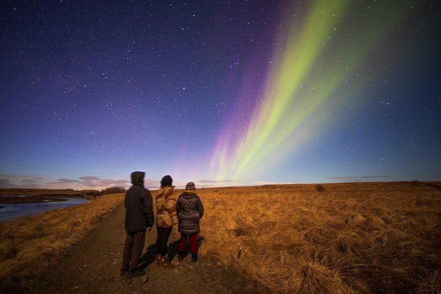 People watching the northern lights in Iceland, a natural phenomenon also commonly seen in Greenland’s night skies.