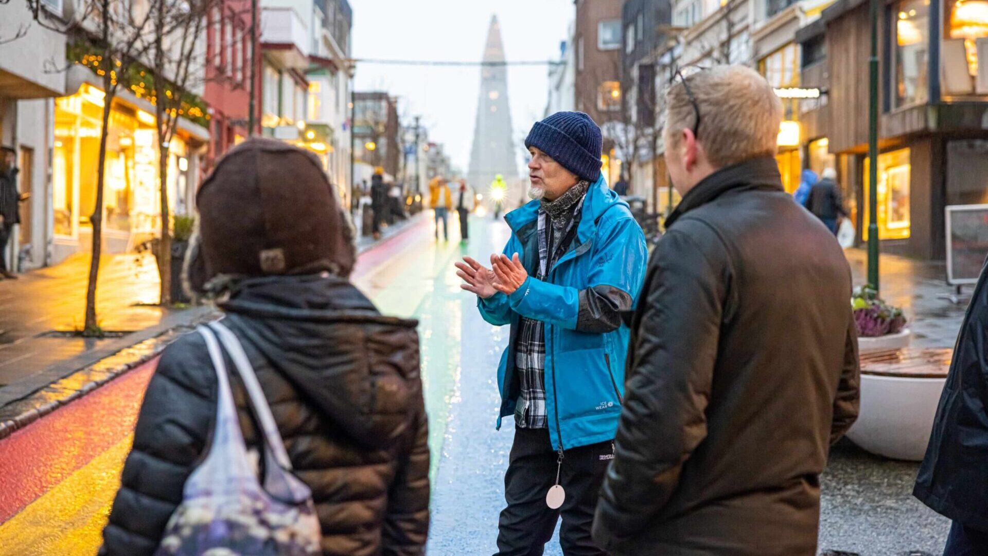 Private walking tour in Reykjavik along colorful rainbow street with Hallgrimskirkja Church in the background.