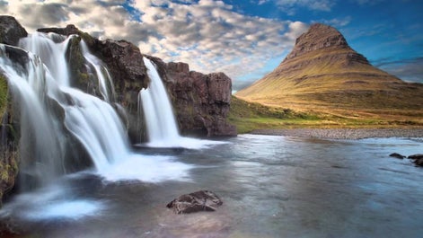 The Kirkjufell mountain with its distinctive cone shape, and the Kirkjufell waterfall in the foreground.