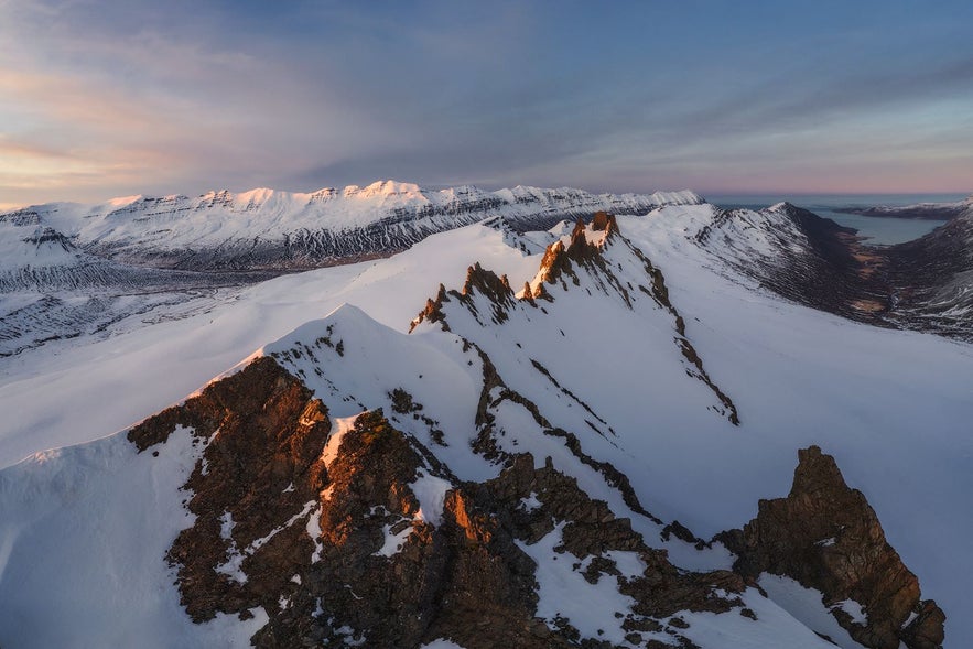 The sun setting over mountains in iceland