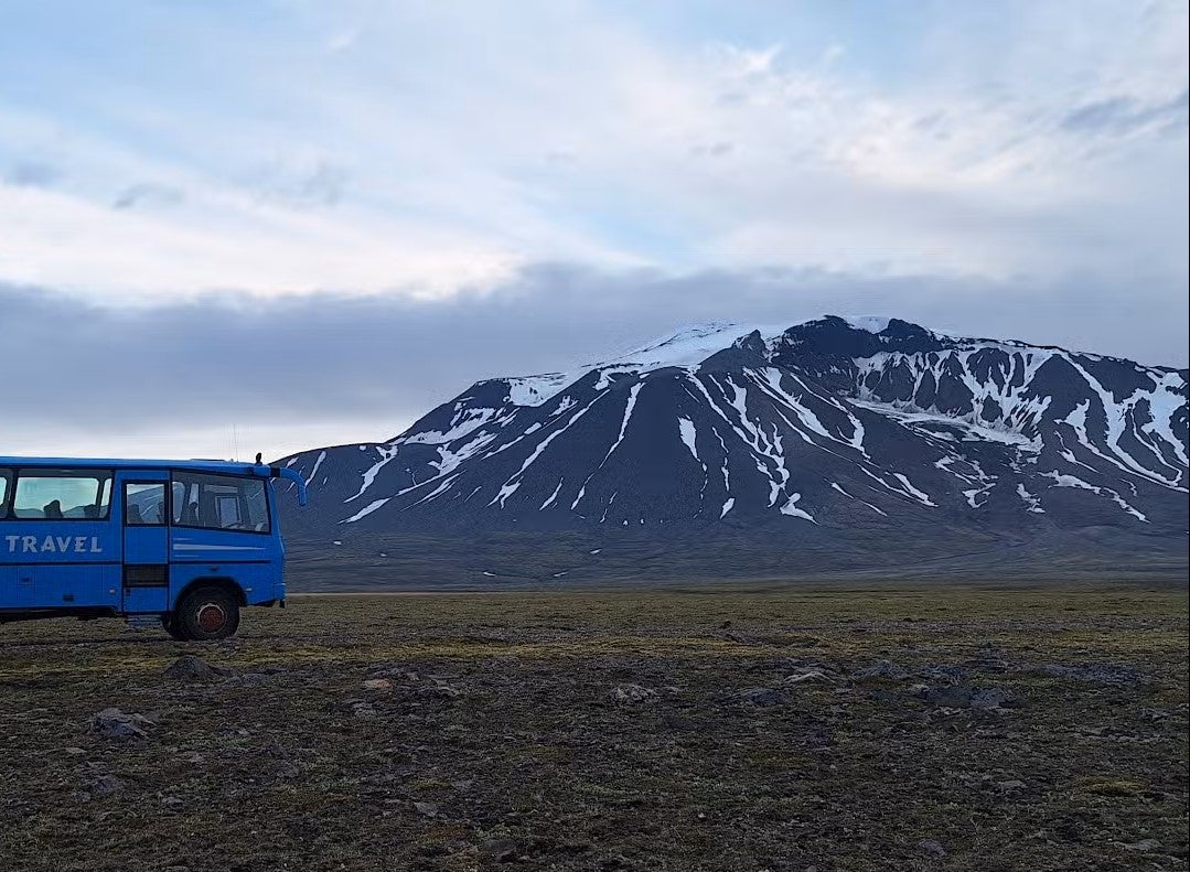 A blue 4x4 truck drives through the Highlands of East Iceland on a 4x4 Highlands tour.