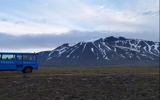 A blue 4x4 truck drives through the Highlands of East Iceland on a 4x4 Highlands tour.