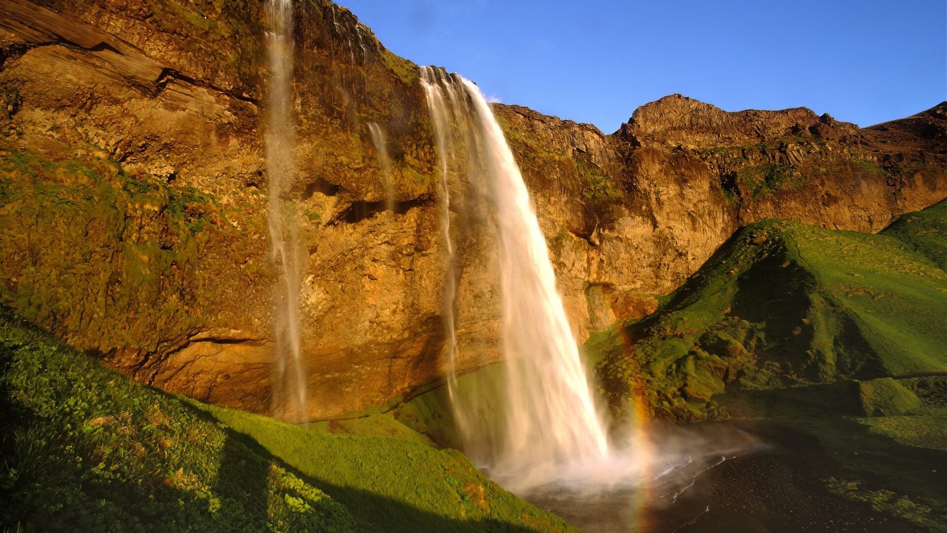 Scenic view of Seljalandsfoss Waterfall at sunset, a popular stop on Iceland’s South Coast.