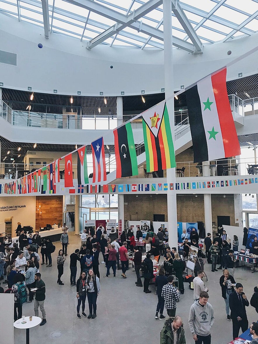 Reykjavik University event showing international student community and flag banners.