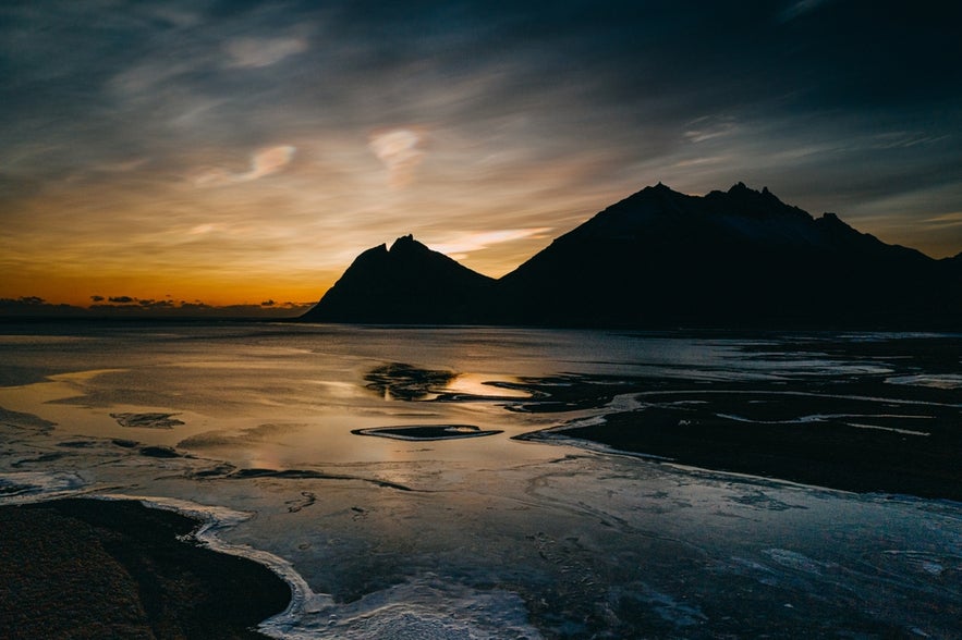 A silhouette of Brunnhorn mountain, also known as Batman Mountain, is outlined by a golden sunset on Iceland’s southeast coast.
