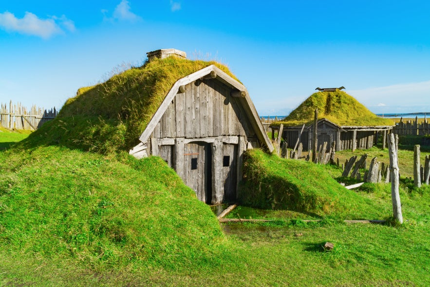 Old wooden houses stand in the Viking Village near Vestrahorn Mountain on the Stokksnes Peninsula in southeast Iceland.