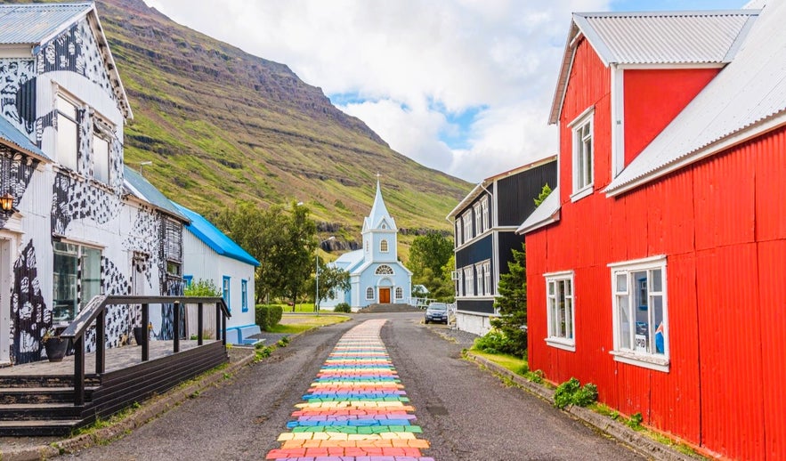 Walking the Rainbow Street to the Blue Church is one of the top things to do in Seydisfjordur for colorful photo spots.