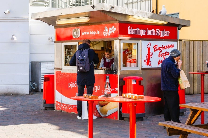 People lining up at Baejarins Beztu Hot Dog Stand in Reykjavik, Iceland, a popular spot for the city’s famous hot dogs. People lining up at Baejarins Beztu Hot Dog Stand in Reykjavik, Iceland, a popular spot for the city’s famous hot dogs.