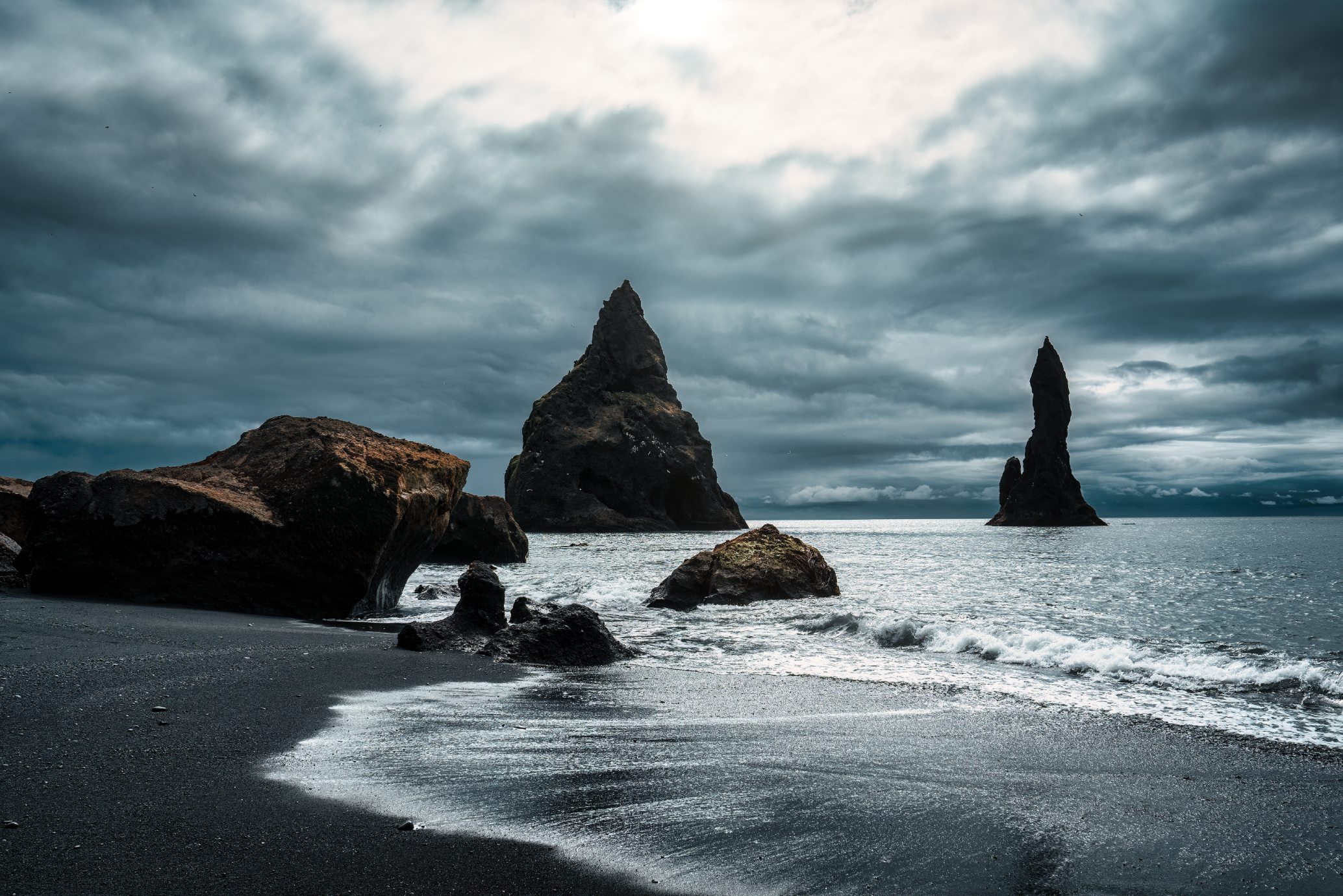 Reynisdrangar Sea Stacks rising from the Atlantic at Reynisfjara Beach.