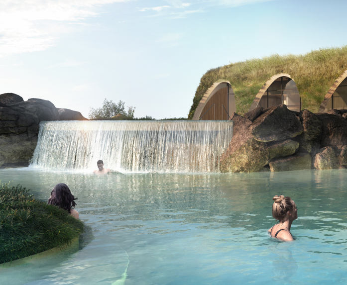 Visitors swimming in Laugaras Lagoon geothermal pool with a man-made waterfall feature.