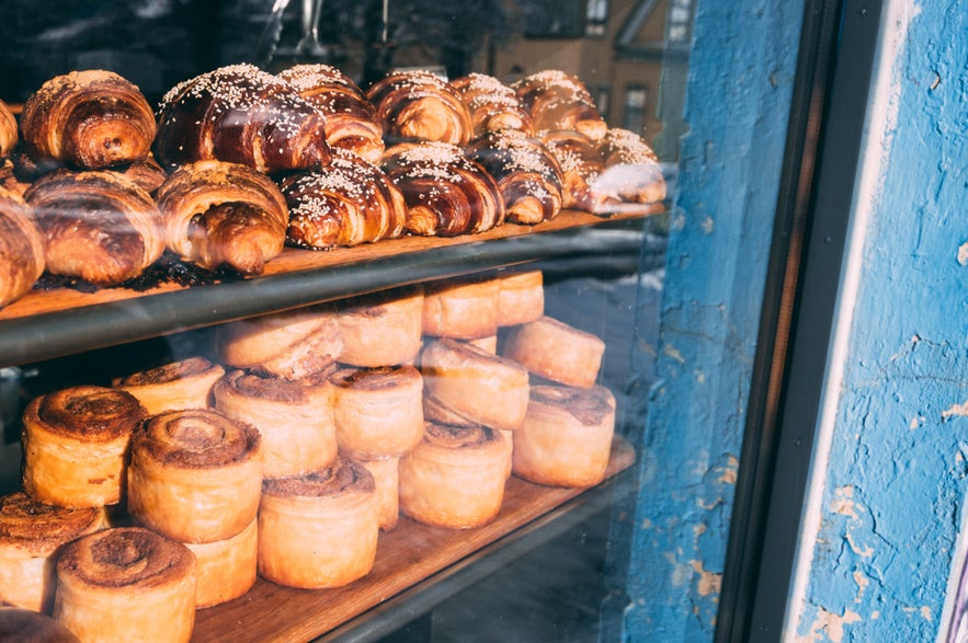 Freshly baked pastries and cinnamon rolls displayed in a window of one of the charming bakeries in Reykjavik, Iceland. Freshly baked pastries and cinnamon rolls displayed in a window of one of the charming bakeries in Reykjavik, Iceland.