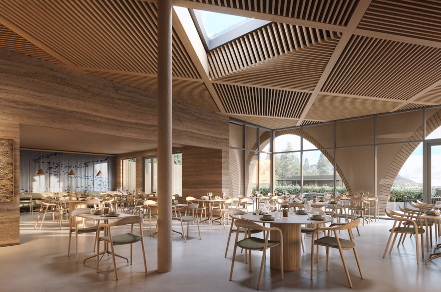 Interior of Ylja Restaurant at Laugaras Lagoon with wooden design, skylight, and large windows overlooking nature.