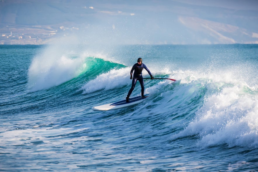 Surfing in Iceland is a thrilling experience, with a surfer riding waves against dramatic coastlines and the cold North Atlantic waters. Surfing in Iceland is a thrilling experience, with a surfer riding waves against dramatic coastlines and the cold North Atlantic waters.