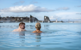 A man and a woman enjoy a soak in the geothermal pool at the Earth Lagoon, formerly known as Myvatn Nature Baths.