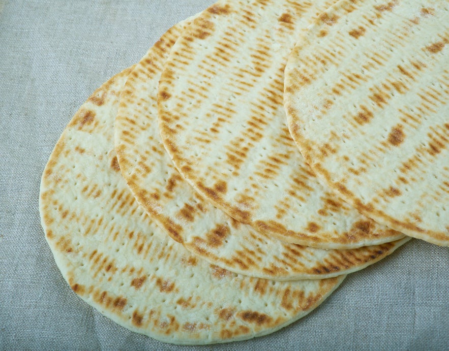 Flatkaka, traditional Icelandic flatbread, soft and round, often served with butter or toppings.