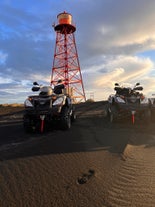 The oldest steel lighthouse in Iceland, standing tall on a captivating black-sand beach in Southeast Iceland.