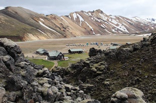 Witness the awe-inspiring Landmannalaugar mountain peak overlooking the serene camping grounds, a perfect escape into the heart of nature.