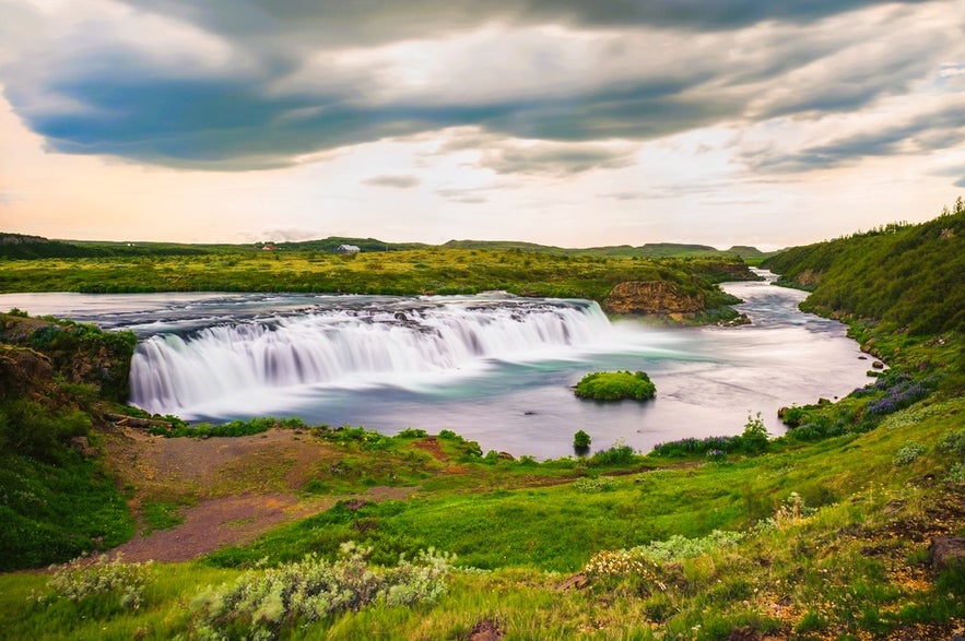 Faxafoss Waterfall near Skalholt and Thingvellir in Iceland surrounded by lush green landscapes and summer scenery. Faxafoss Waterfall near Skalholt and Thingvellir in Iceland surrounded by lush green landscapes and summer scenery.