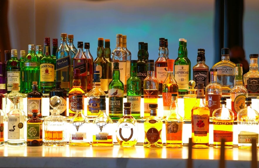 Wide selection of Icelandic liquor and spirits displayed at a Reykjavik bar featuring whiskey, vodka, and gin brands.