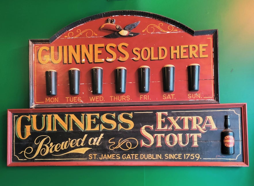 Vintage Guinness sign at The Irishman Pub in Reykjavik with pints for each day of the week.