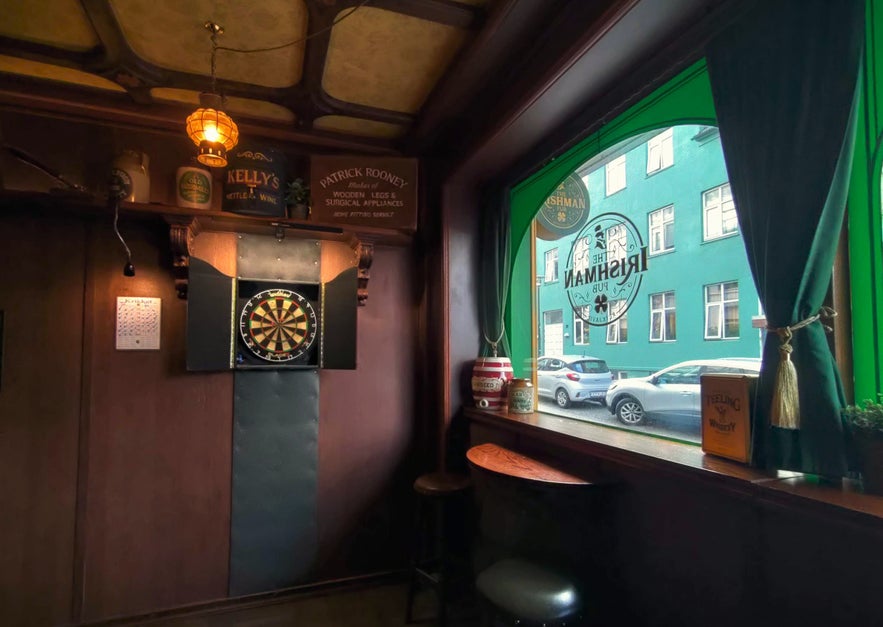Dartboard and cozy seating corner at The Irishman Pub in Reykjavik.