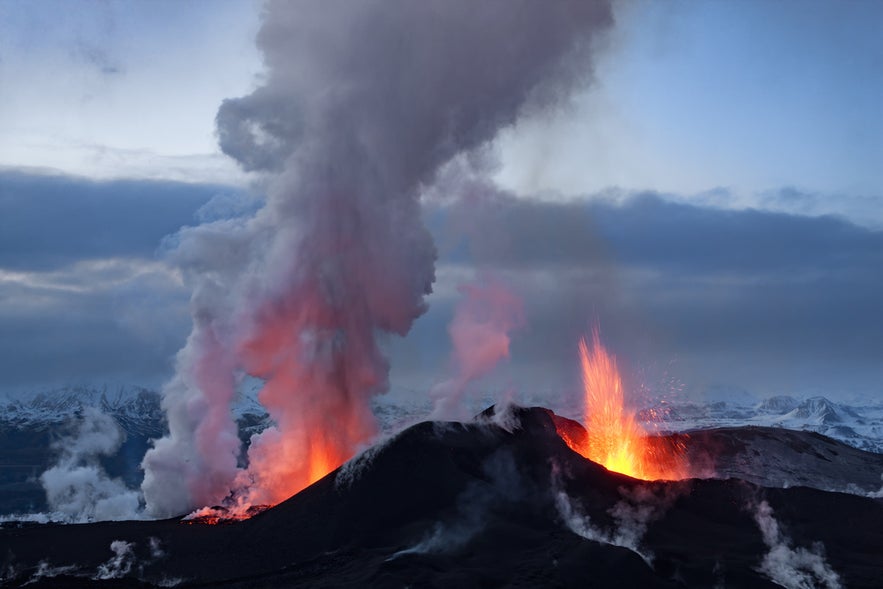 Volcano eruption at Eyjafjallajökull in South Iceland with ash and lava against the glacier.