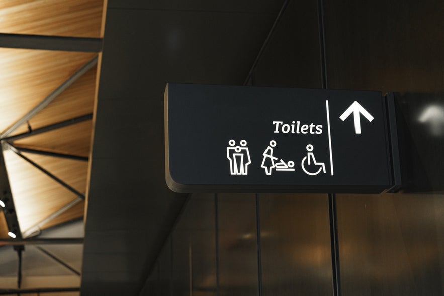 Modern public toilet sign on the wall.