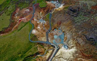 Wooden walkway winding through hot springs and fumaroles at Krysuvik in Iceland.